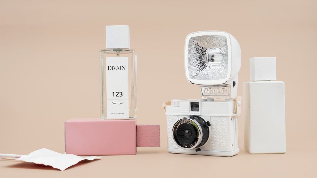 Divain equivalent perfumes next to an old camera