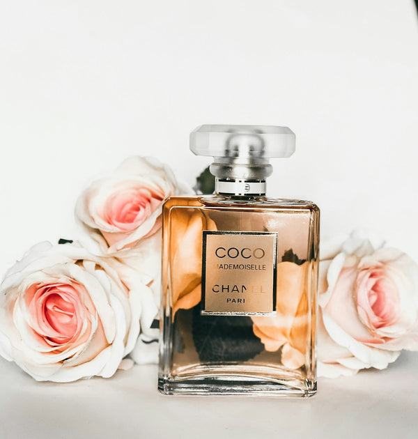 Warm autumn perfume bottles on a neutral background