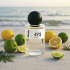 Divain.495 unisex perfume bottle with lemons and limes on the beach.