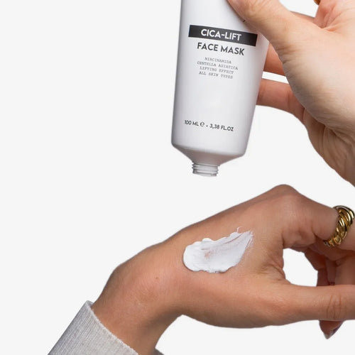 Divain Care Cica-Lift facial mask applied to the skin of the hand