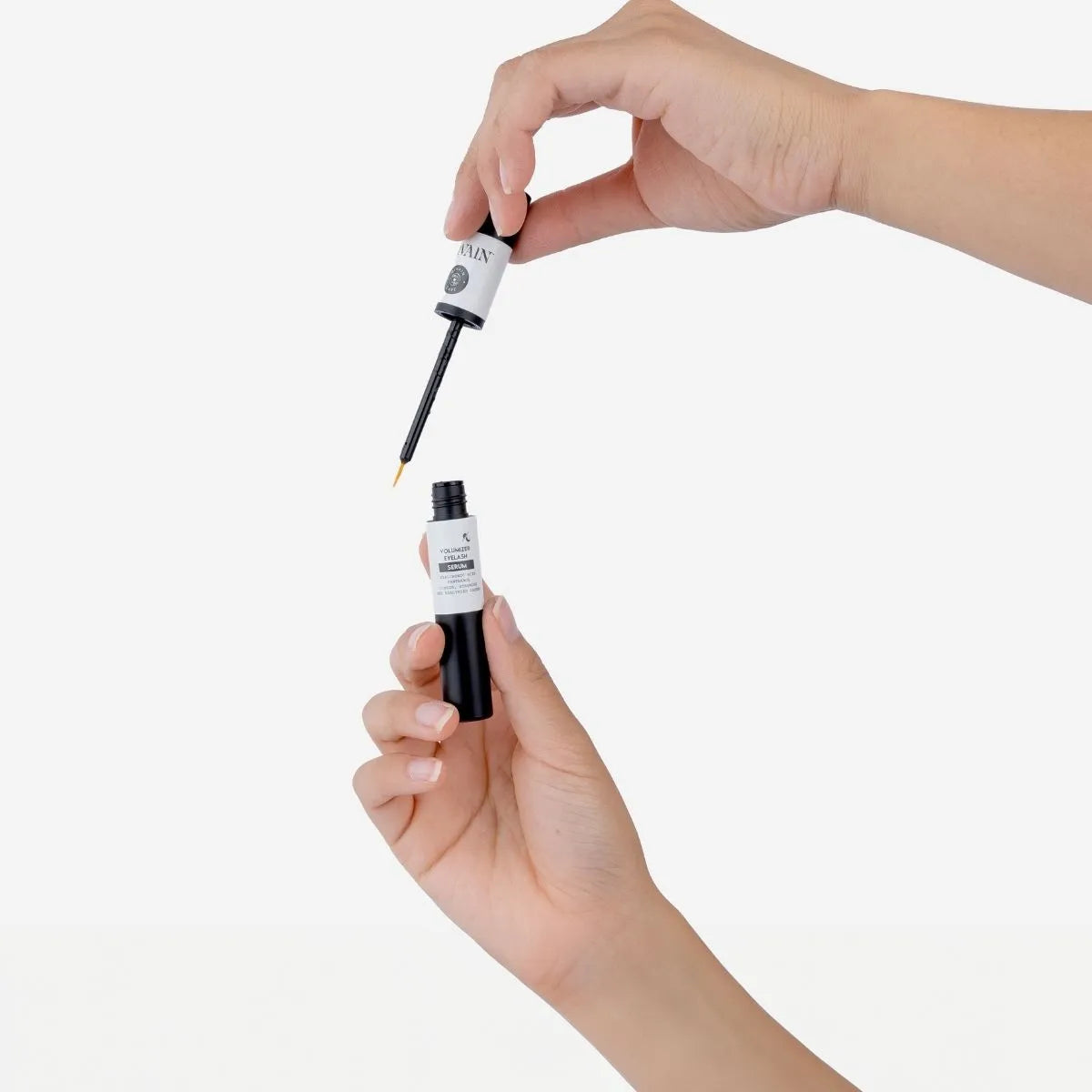 Divain Care eyelash volumizing serum with hand applicator.