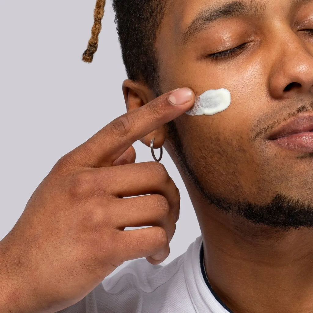 Application of Divain Care cream on the skin of the male face.