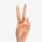 Divain Care facial sunscreen on the fingers of one hand where the two shades bronze and light can be seen.