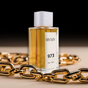 Perfume divain-973 surrounded by a gold chain giving a sense of luxury.