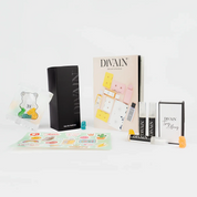 Opened divain package containing divain-416 perfume, stickers, and gummy candies
