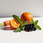 Carrot, basil, orange and blackcurrants representing the olfactory notes of the perfume.