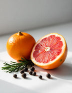 Orange and grapefruit representing the olfactory notes of the perfume.