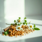 Chamomile and pieces of bark representing the olfactory notes of the perfume.