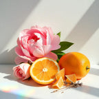 A rose and a peony with mandarins around them representing the olfactory notes of the perfume.