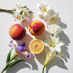 Peaches, iris flower, magnolia and gardenia representing the olfactory notes of the perfume.