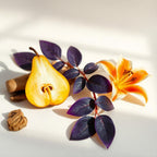 Half a pear, violet leaves and hedione representing the olfactory notes of the perfume.