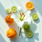 Oranges, lime and a lily flower representing the olfactory notes of the perfume.