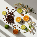 Lime, jasmine, almond and coffee beans representing the olfactory notes of the perfume.