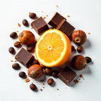 Orange, chocolate, hazelnut and coffee beans representing the olfactory notes of the perfume.