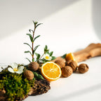 Orange, moss and nut representing the olfactory notes of the perfume.