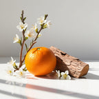 Mandarin and cedar representing the olfactory notes of the perfume.