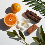 Orange, wood and white cuaba flower representing the olfactory notes of the perfume.