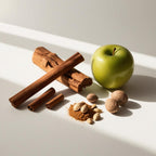 Green apple, cinnamon and wood representing the olfactory notes of the perfume.