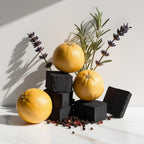 Pepper, lavender and charcoal representing the olfactory notes of the perfume.