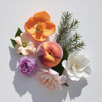 Peach, calendula, violet and gardenia representing the olfactory notes of the perfume.