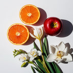 Mandarin, iris flower and red apple representing the olfactory notes of the perfume.