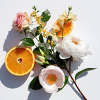 Orange, rose and tiare flower representing the olfactory notes of the perfume.