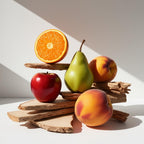 Cedar, pear, red apple and orange representing the olfactory notes of the perfume.