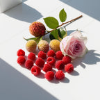 Lychee, rose and raspberry representing the olfactory notes of the perfume.