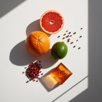 Grapefruit and pink pepper representing the olfactory notes of the perfume.