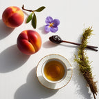 Nectarine, tea, violet and moss representing the olfactory notes of the perfume.