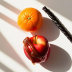 Mandarin, caramel apple and licorice representing the olfactory notes of the perfume.