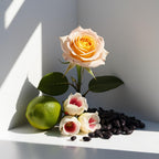Rose, orange blossom and bergamot representing the olfactory notes of the perfume.