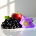 Red apple, violet and blackcurrants representing the olfactory notes of the perfume.