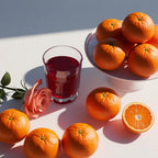 Orange, pomegranate and rose representing the olfactory notes of the perfume.